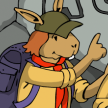 Eine Pfadfinderin zeigt auf die bemalte Wand.